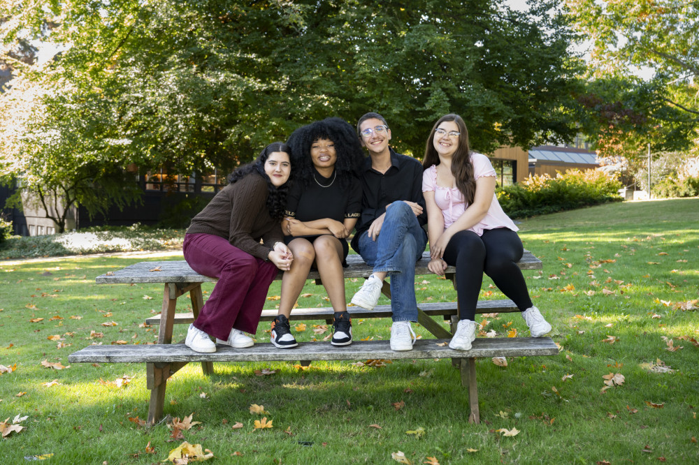 Phonathon Callers sitting on a picnic table smiling