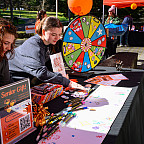 Students spin the prize wheel at last year's Day of Giving festival.