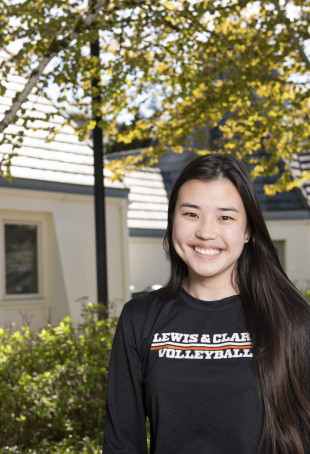 Katie smiling outside wearing a black L&C volleyball shirt.