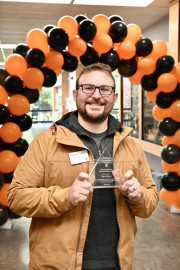 Ben Meoz poses with the Excellence in Innovation award.