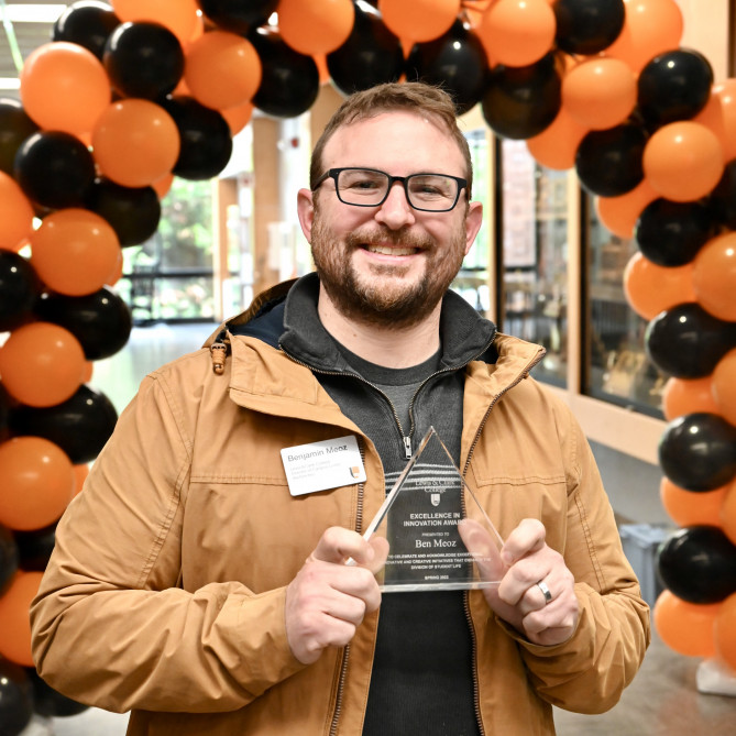 Ben Meoz poses with the Excellence in Innovation award.