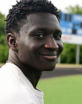 A young male smiling at the camera