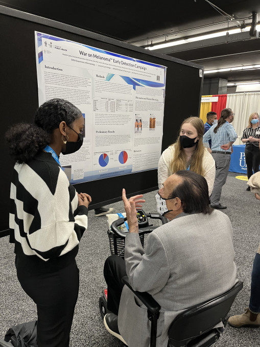 Labbies presenting research to Dr. Zimbardo at WPA 2022