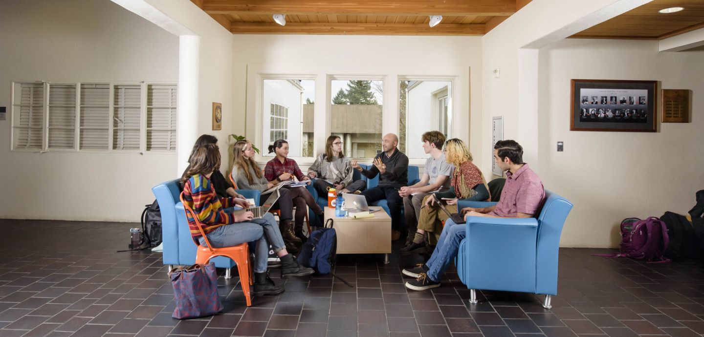 Students and faculty sitting together, talking.