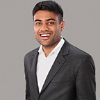Headshot of Dr. Geetinder Goyal wearing a white shirt and grey jacket