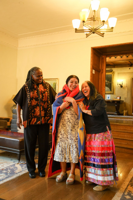President Holmes Sullivan, Azucena Morales Santos and Karen Graves '81 at the 2024 Native Graduation.