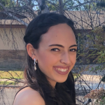 Leah smiling, turned slightly toward the camera