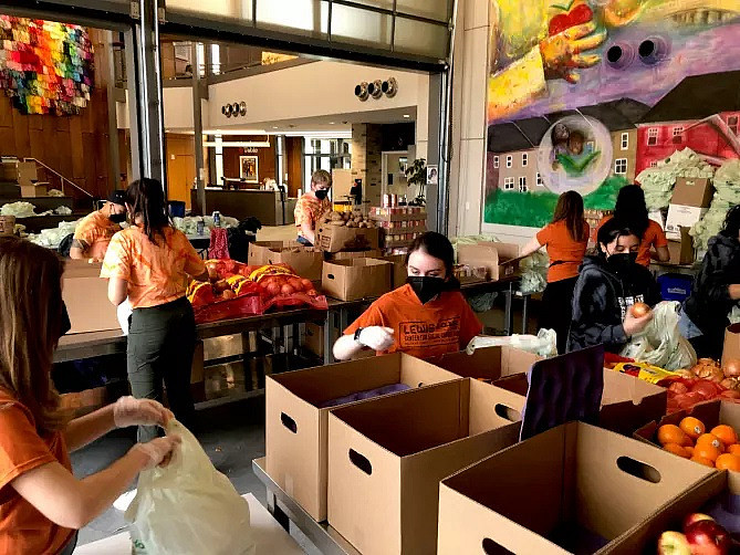 Lewis & Clark students work to sort fruit into kits at their volunteer site in D.C.