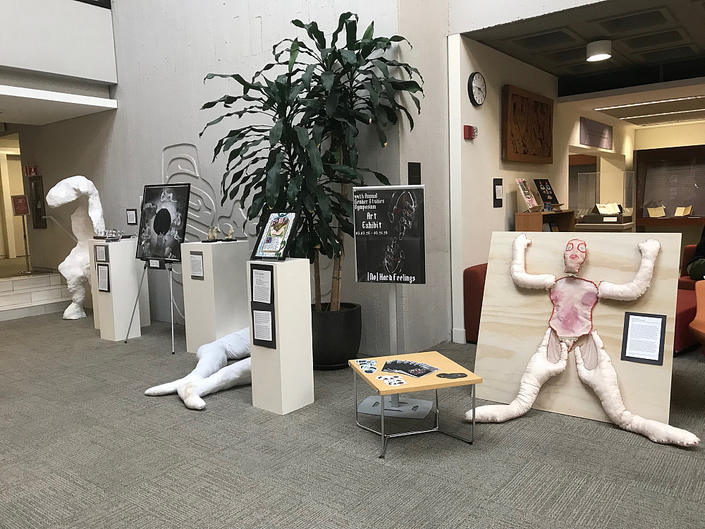 Small collection of art on pedestals, easels, and free-standing