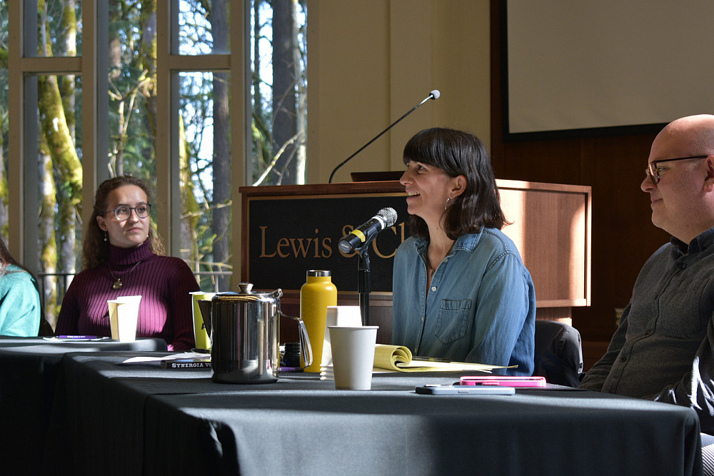 seated woman speaking into microphone