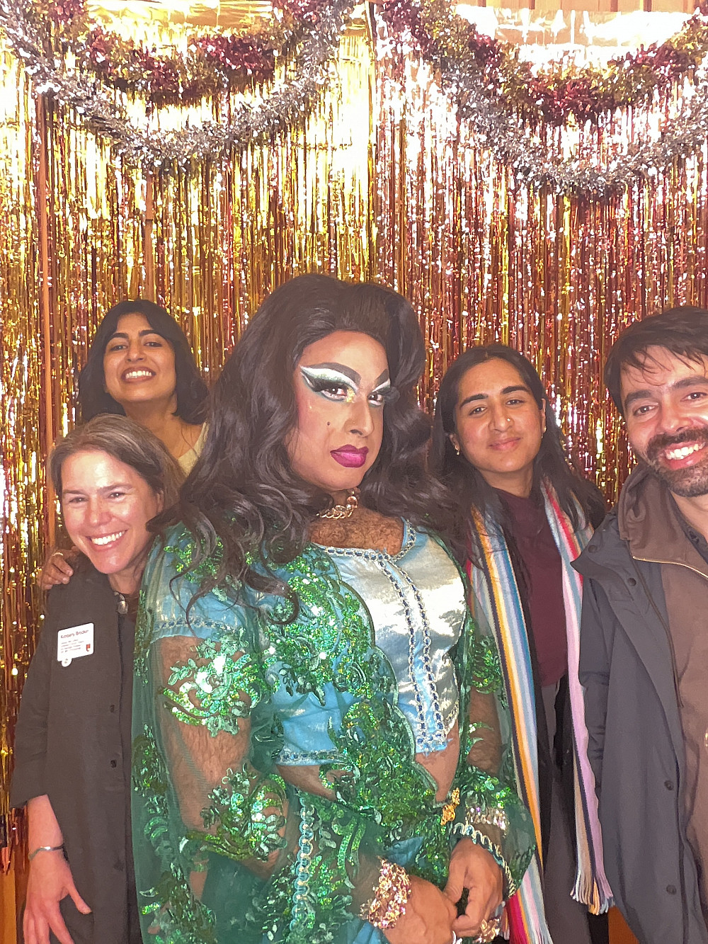 group of 4 gather around drag queen in photo booth