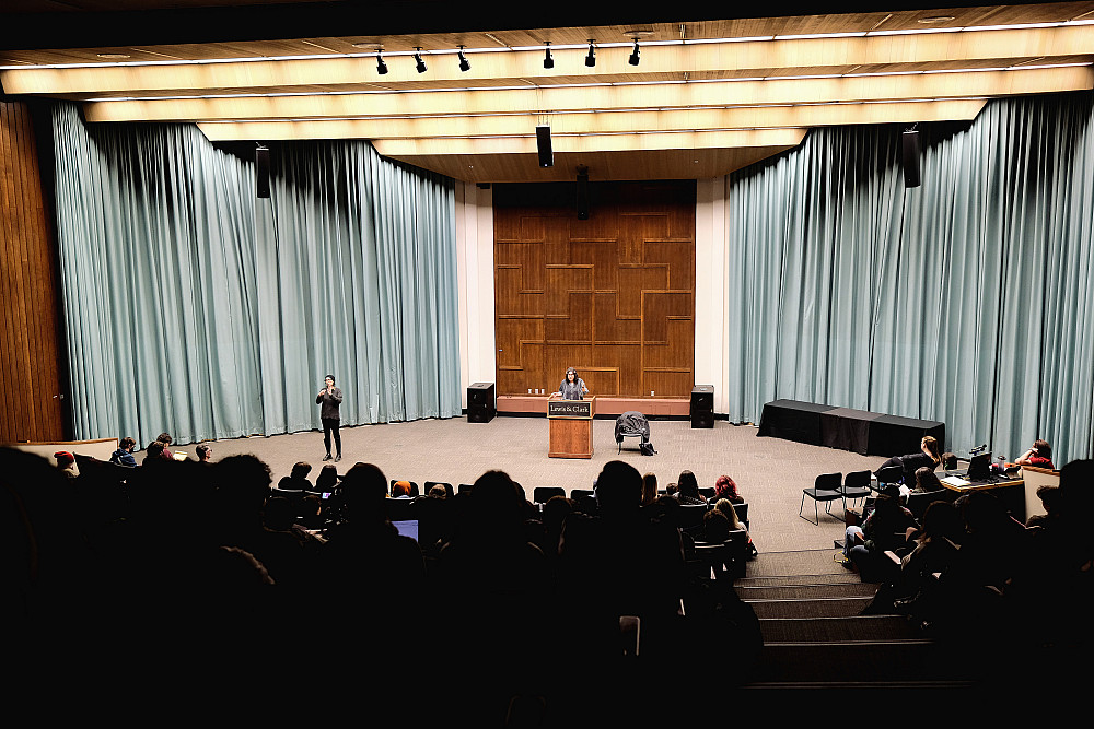 perspective of speaker at podium from darkened theater seating