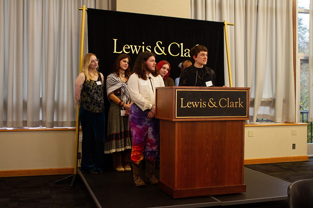 6 students at a podium