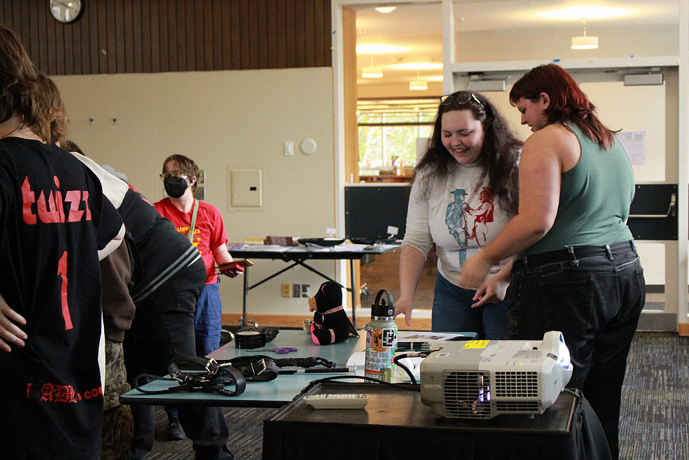 People standing around a table display.