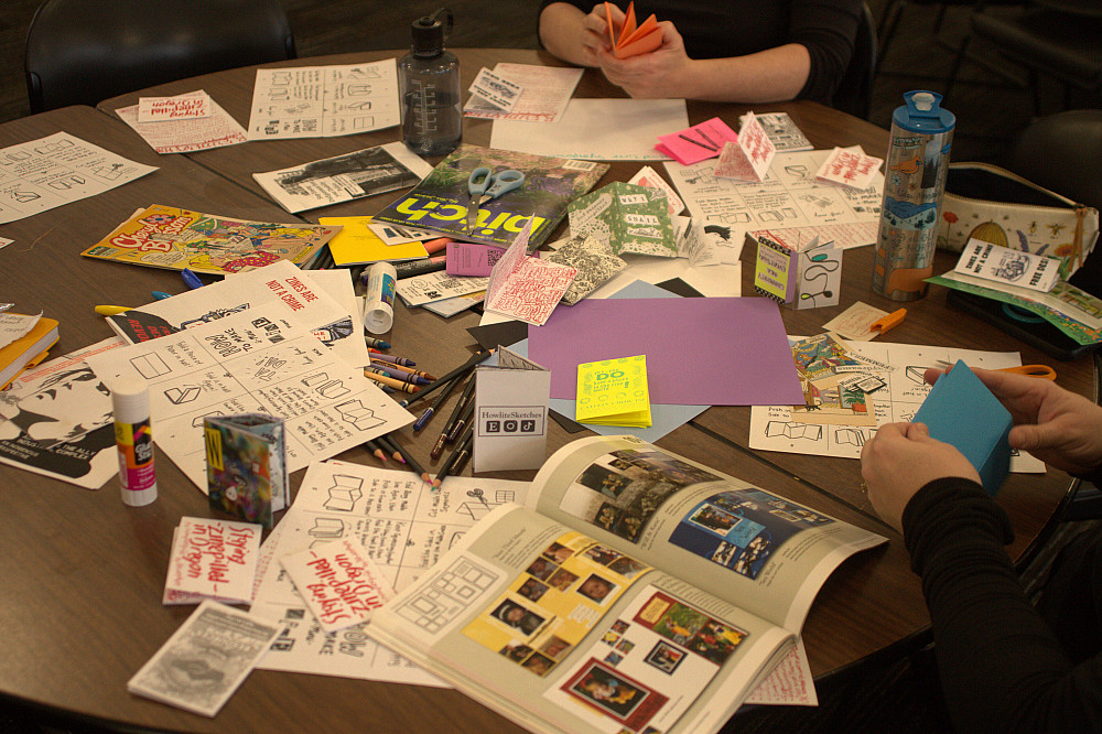 A table covered with supplies for zinemaking