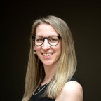 Headshot of Emily Helft with black background