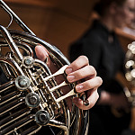 Close-up image of student playing wind instrument.