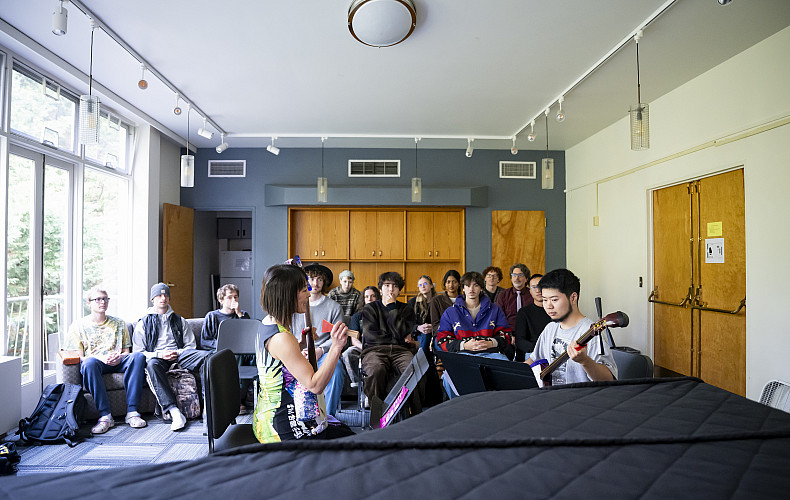 Students in a music class playing guitar.