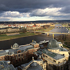 Cityscape image showing buildings and a river running through the city.