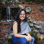 Deenie posing near a waterfall.