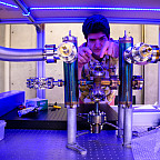 A professor working on a large metal instrument.