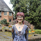 Burton smiling at the camera outside Frank Manor House.