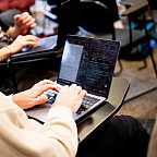 A student typing on a laptop.