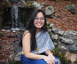 Deenie posing near a waterfall.