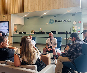 A group of people sitting in a lobby together.