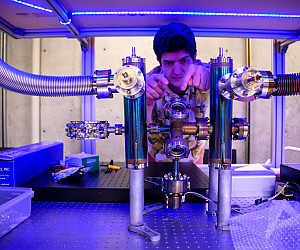 A professor working on a large metal instrument.