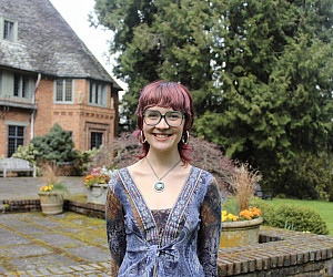 Burton smiling at the camera outside Frank Manor House.