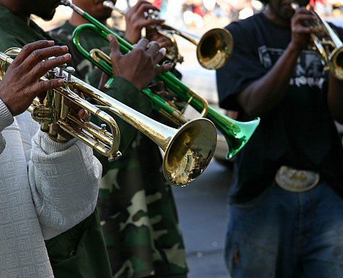 Close up of a person playing a trumpet.