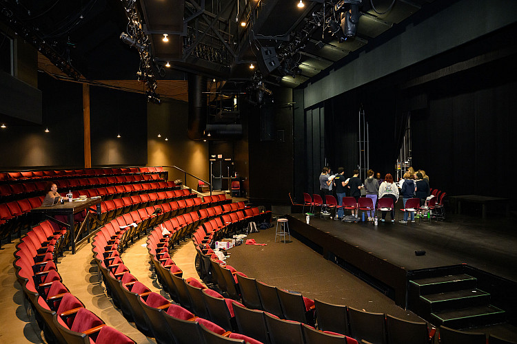 Photo inside the main stage of the theatre with students working on stage.