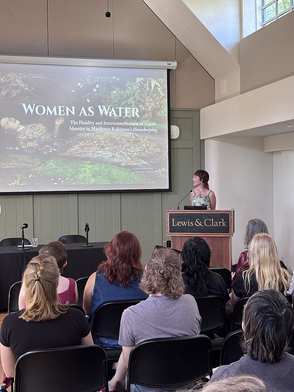 Burton Scheer '25, with the title slide for “Women as Water: The Fluidity and Interconnectedness of Female Identity in Marilyn...