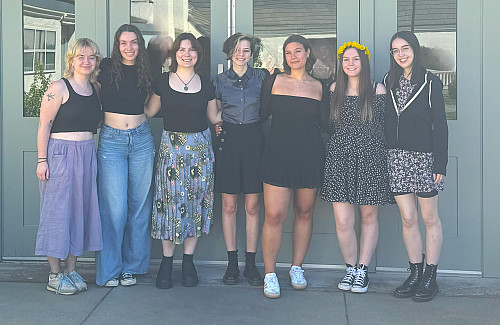 group of college students standing arm-in-arm