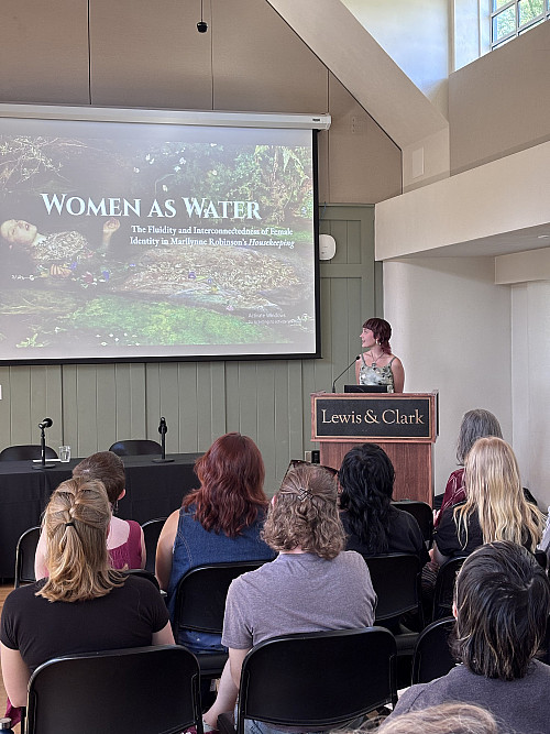 Burton Scheer '25, with the title slide for “Women as Water: The Fluidity and Interconnectedness of Female Identity in Marilyn...