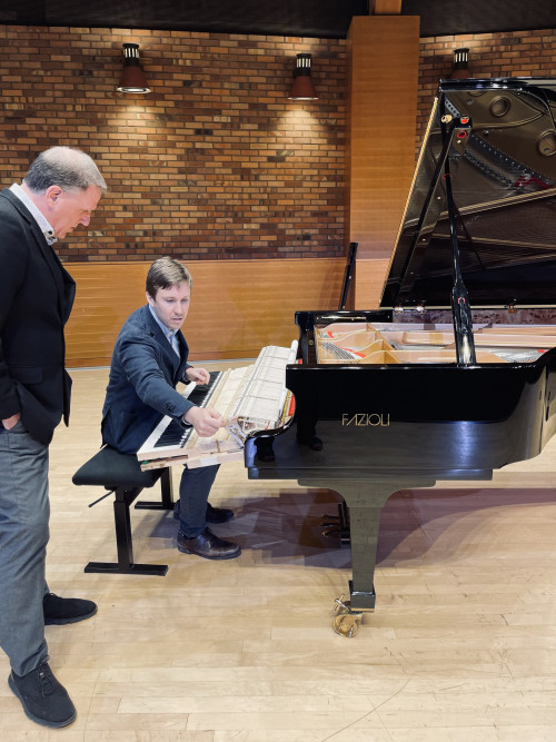 Luca Fazioli and Mitch Paola inspecting the instrument