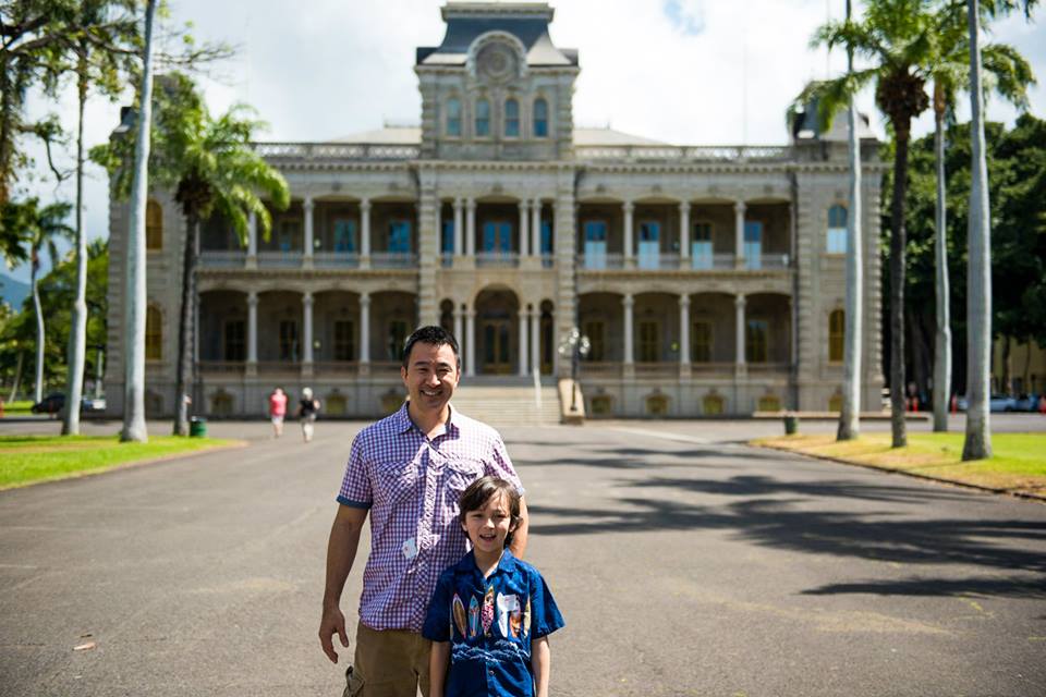LC Orchestra Director Lance Inouye and his son in front of Iolani Palace