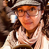 Dr. Leonard wearing a hat and scarf, holding a cup of coffee
